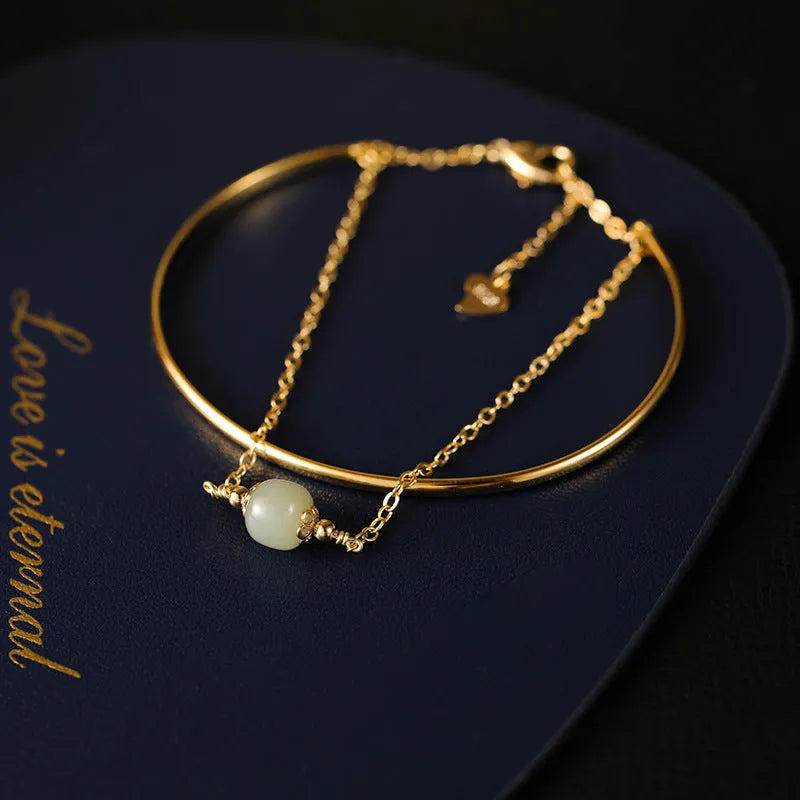 Women's jade bracelet with gold inlay lucky bead design in single, double, or three bead versions.