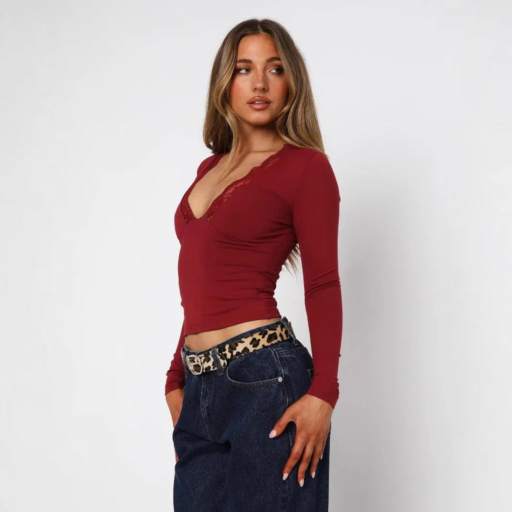 Women's slim fit black top with lace flower shoulder detail and long sleeves
