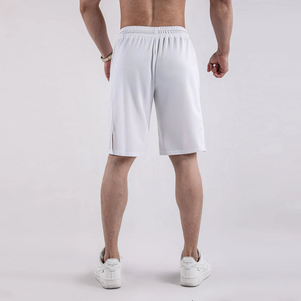 Man wearing loose-fitting black quick-dry mesh fitness shorts with an elasticated waistband.