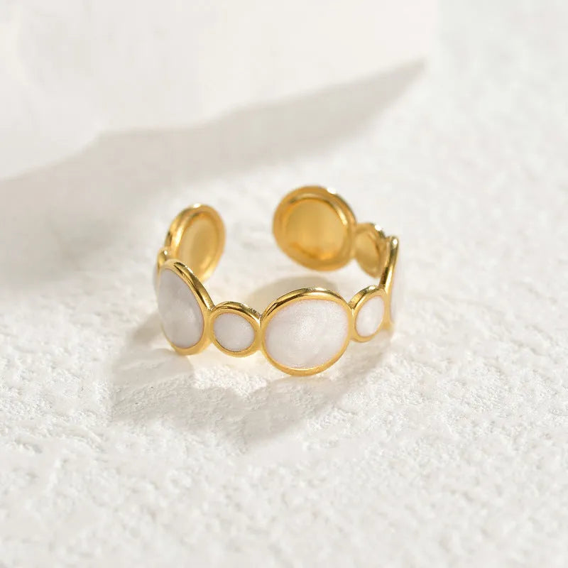 A geometric adjustable ring for women made of electroplated stainless steel on a plain background.