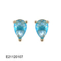 A pair of brass gold-plated drop earrings with a pear-shaped zircon stone, in a candy colour.