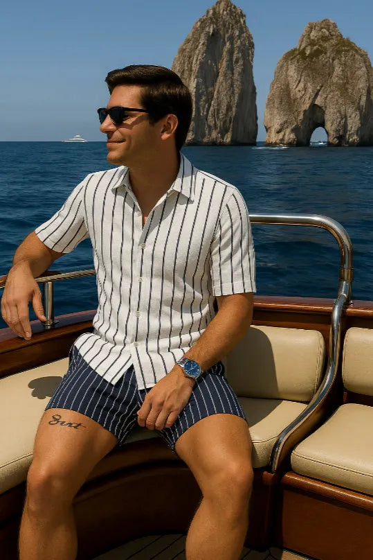 Men's light blue beach shirt and shorts set on a hanger, showing casual styling.