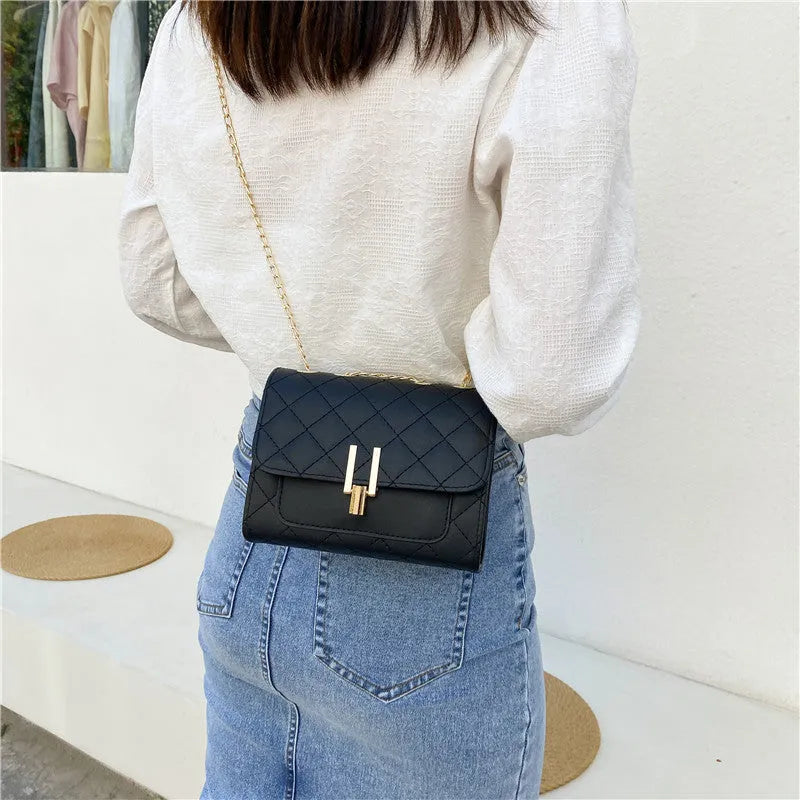 Women's black crossbody bag with diamond lattice chain strap showing 17.5cm width dimensions