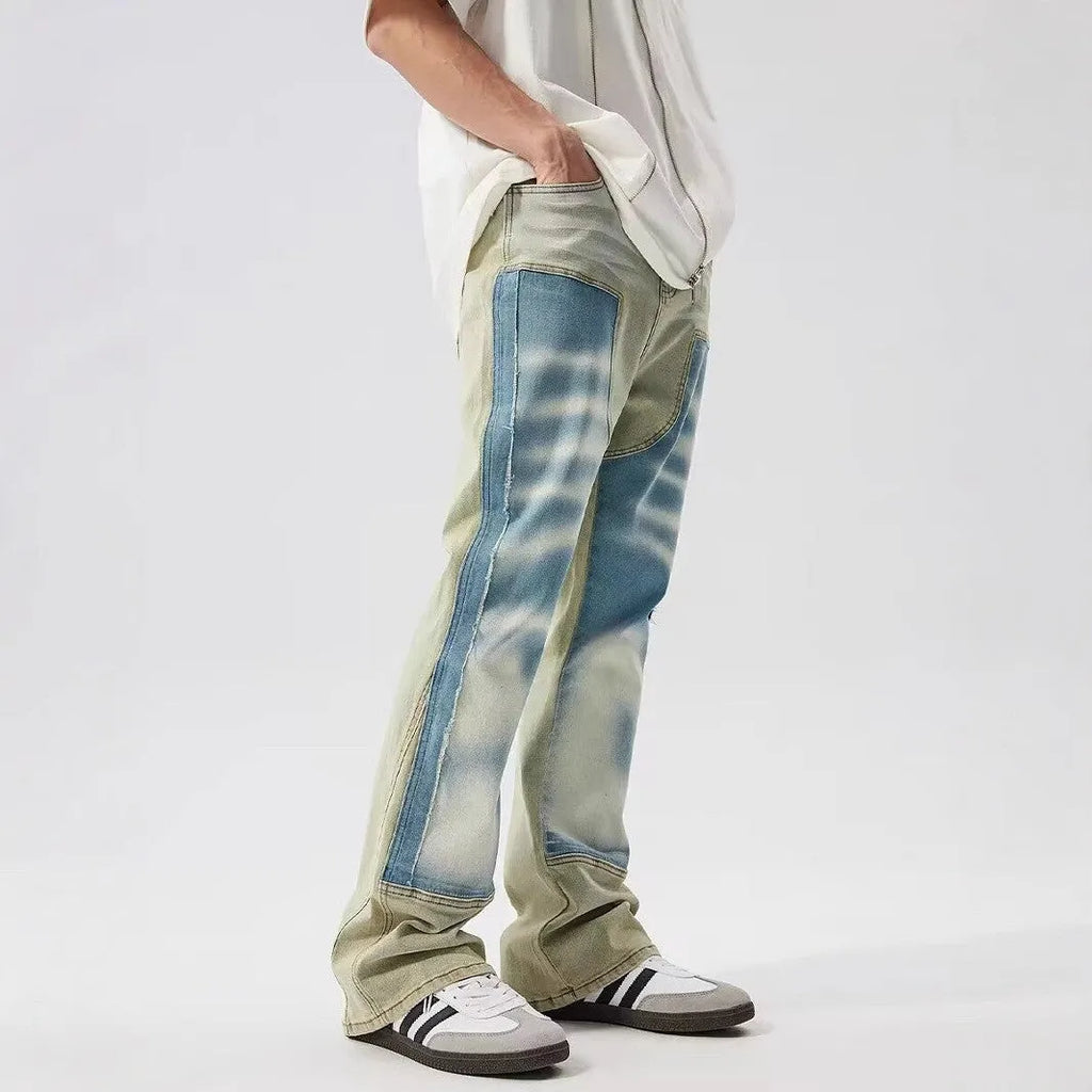 Retro yellow and blue patchwork splash-ink damaged design denim jeans on a mid-waist fit.