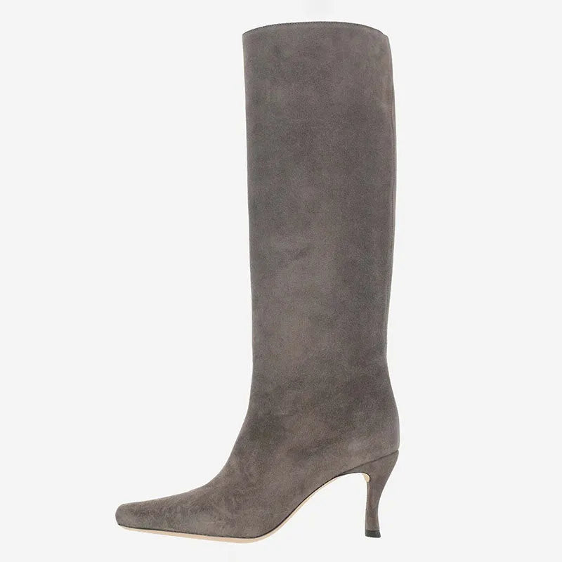 Women's black square toe cowboy boot with microfiber upper on a wooden background.