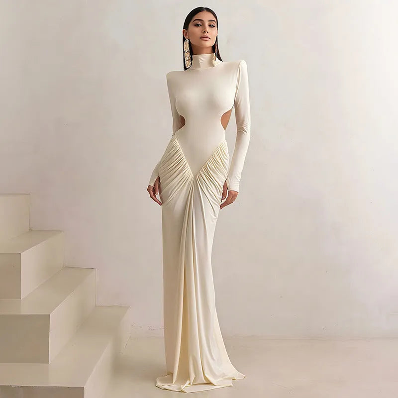 Long sleeve high collar slim fit dress with pleated backless detail in light apricot colour.