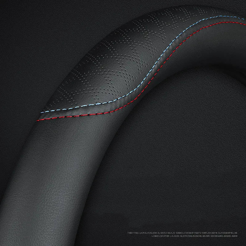 Black steering wheel cover with two-colour stitching, showing napa leather texture and a 38cm diameter.