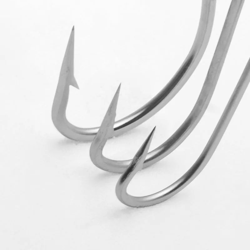 Assortment of multi-specification alloy sea fishing hooks for boat fishing on a blue background.