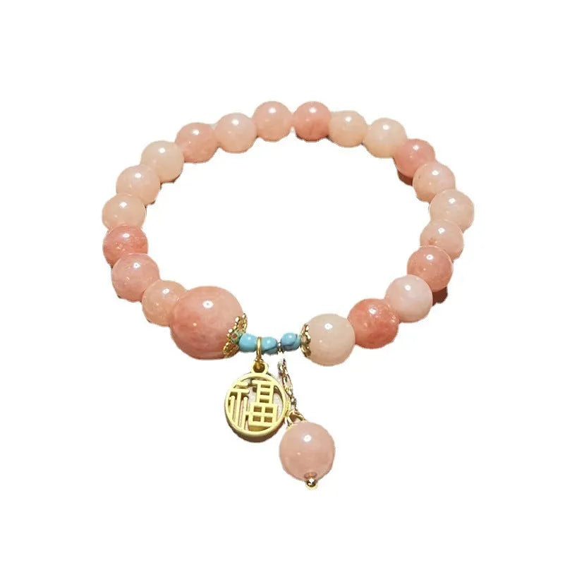 Pink natural stone set on a simple alloy chain bracelet for women.