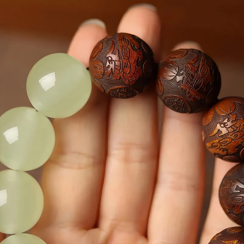 Rosewood bracelet with carved Fu character design and flexible ring construction in amass fortunes colour