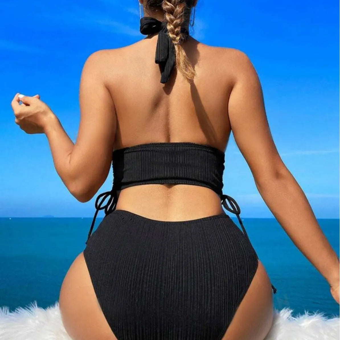 Women's black lace-up halter bikini set with brief bottoms on mannequin