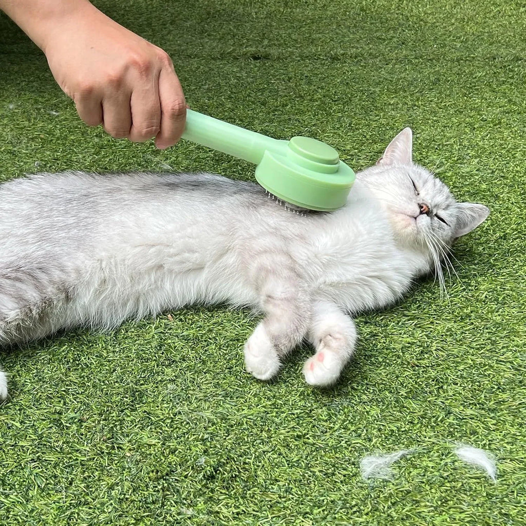Green and yellow 2-in-1 pet grooming and deshedding brush with curved stainless steel teeth on a white background.