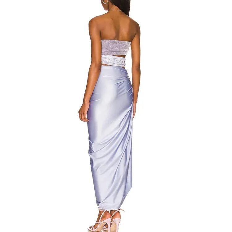 Purple one-piece swimsuit and matching wrap skirt set on a hanger.