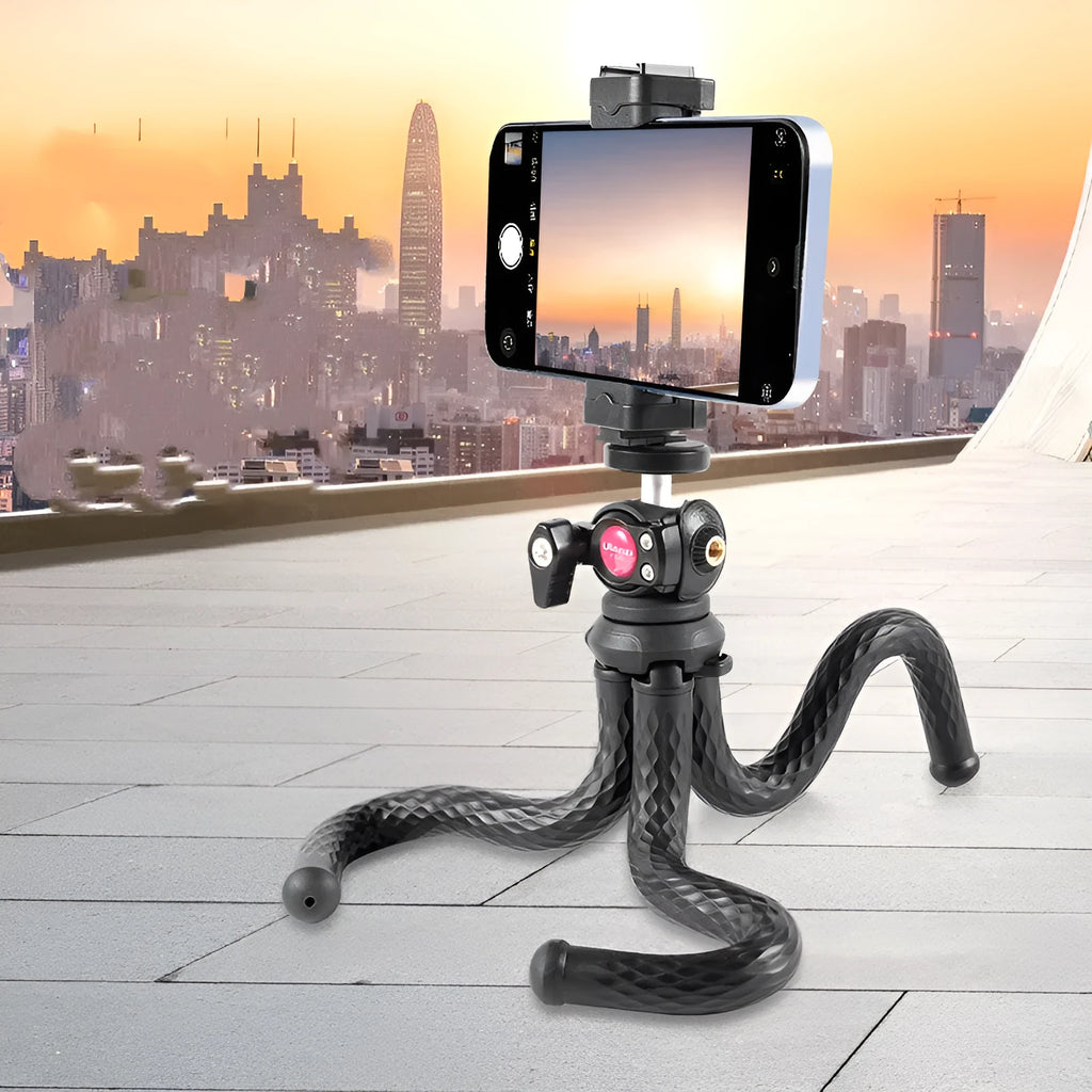 Black octopus-style mobile phone tripod with clip extended to 360mm on a table.
