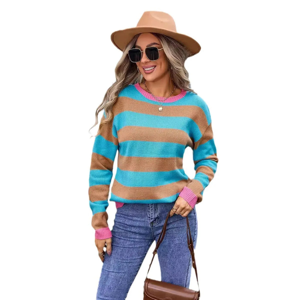 Women's loose fit acrylic knit sweater in blue with striped pattern, long sleeves and round neck.