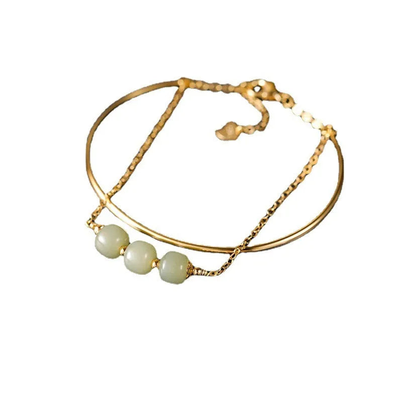 Women's jade bracelet with gold inlay lucky bead design in single, double, or three bead versions.