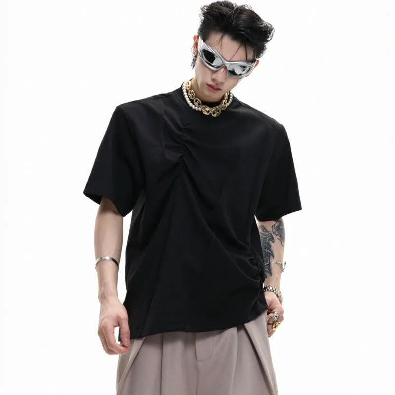 Men's black cotton t-shirt with three-dimensional pleats and asymmetric stitching on a loose fit.