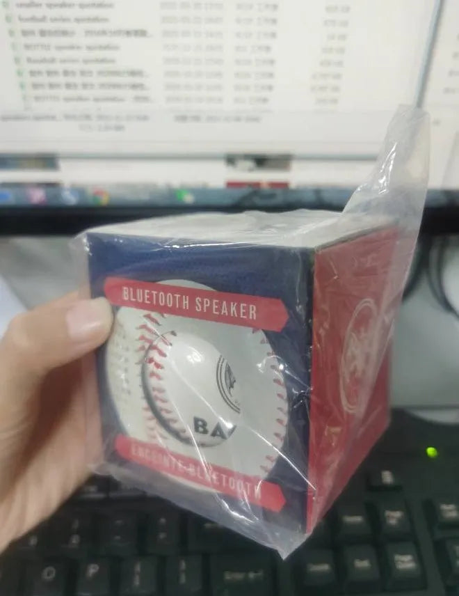 Baseball-shaped Bluetooth speaker in green, orange, or white colours with USB charging port