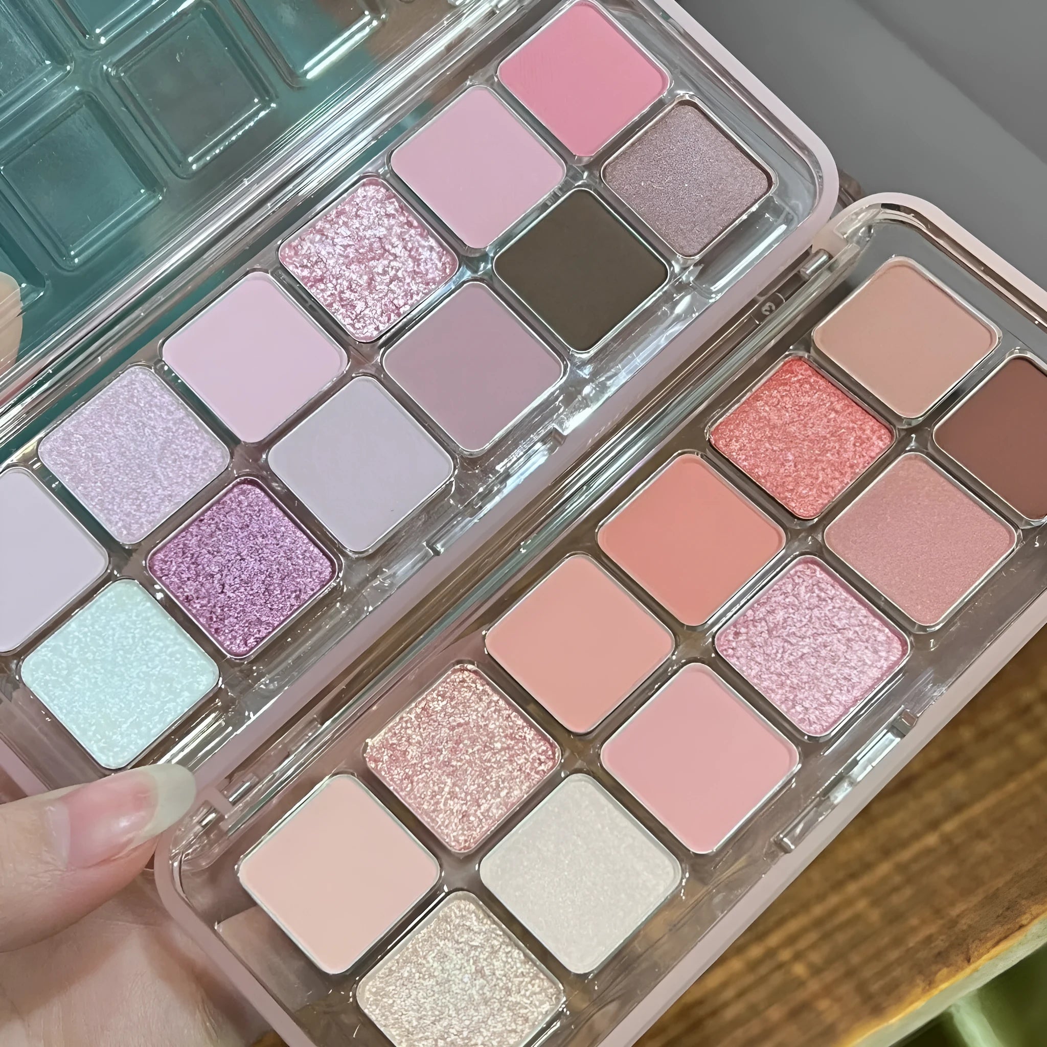 Makeup eyeshadow palette showing twelve different colours in compact case