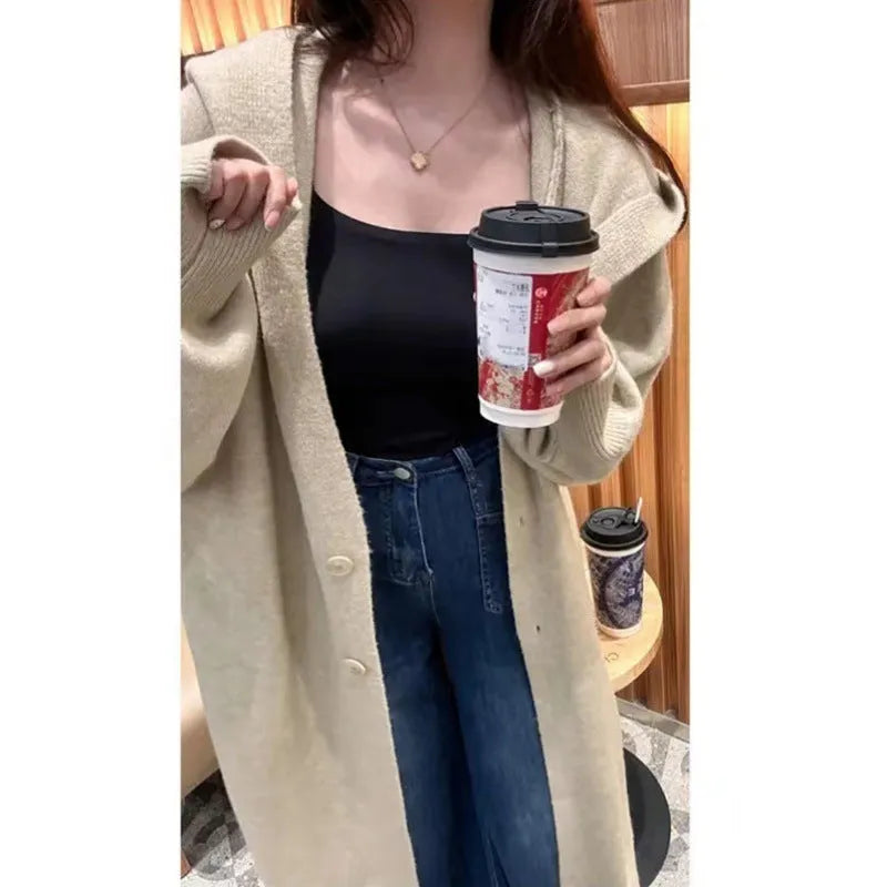 Women's long brown hooded knitted cardigan with a below-the-knee length and loose fit.