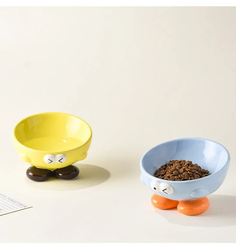 Blue oblique tall ceramic pet bowl with a cute expression design for cats and dogs.