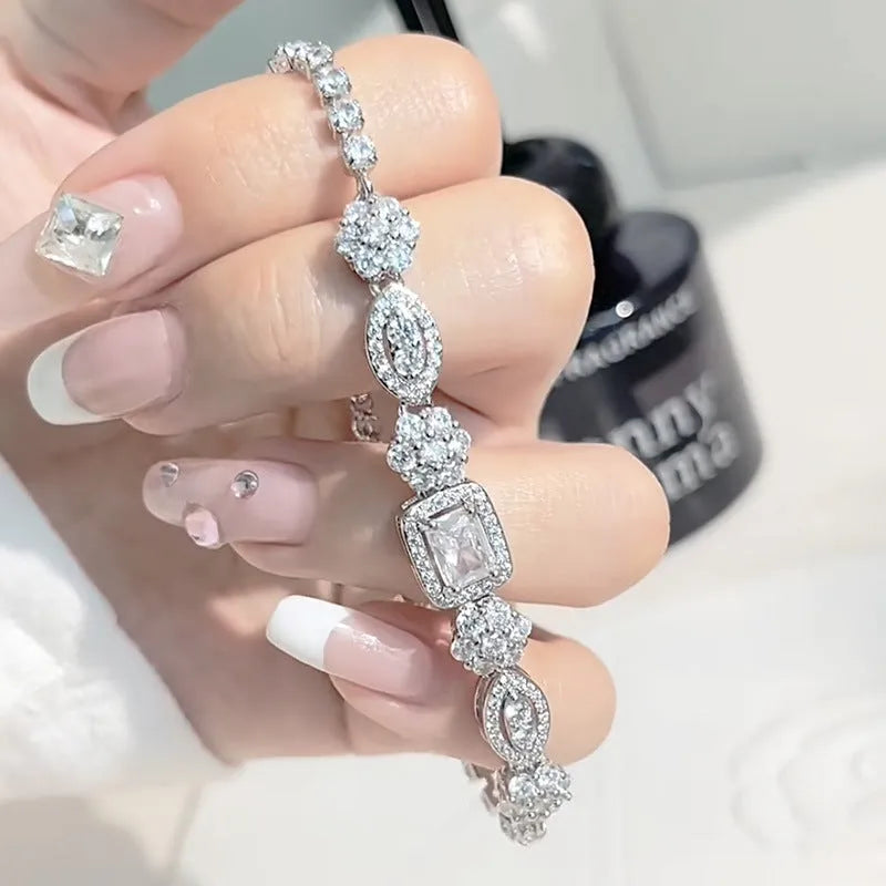 Women's silver-toned geometry bracelet with inlaid clear stones on a model's wrist.