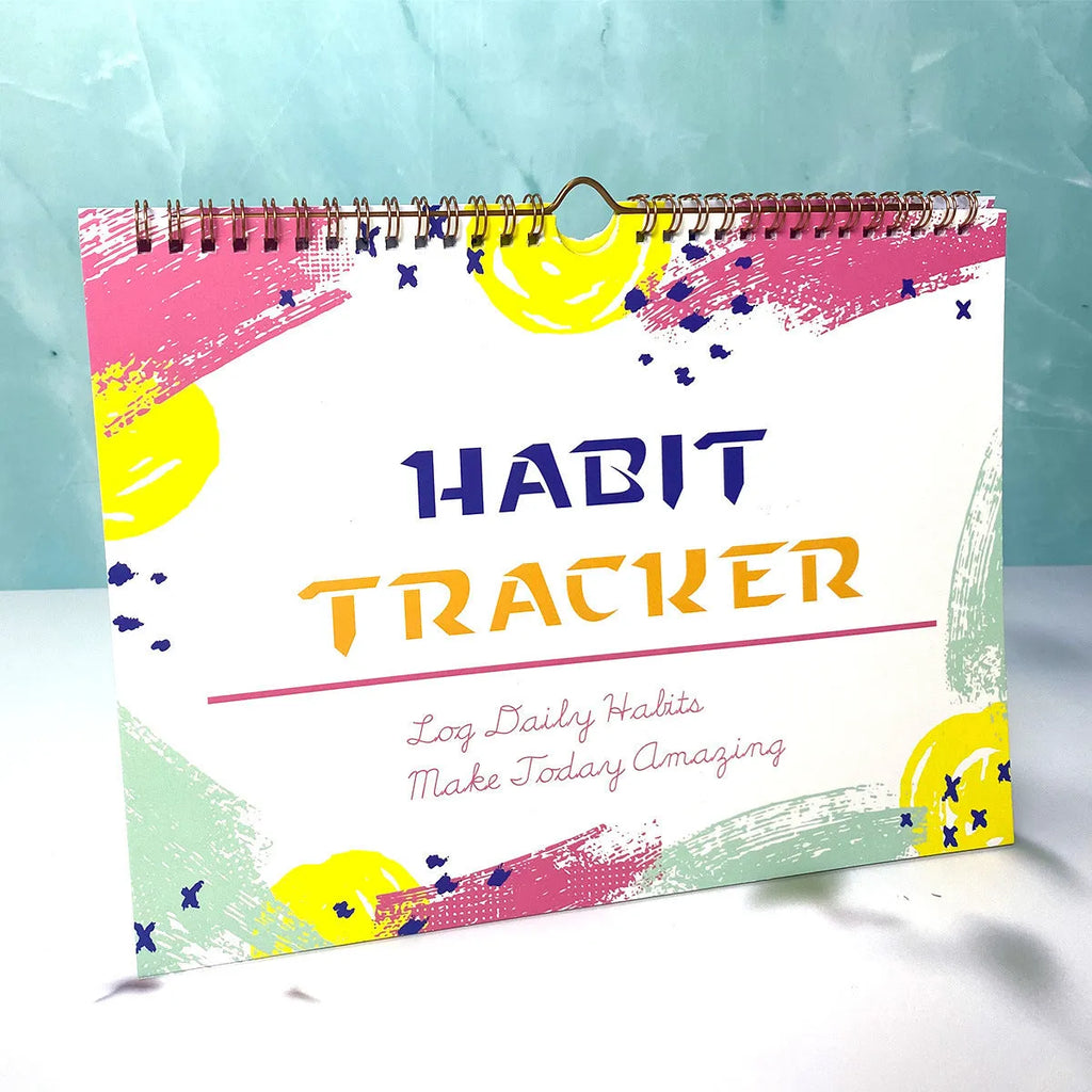 A5 habit tracking planner book open on a table, showing interior pages for schedule recording.