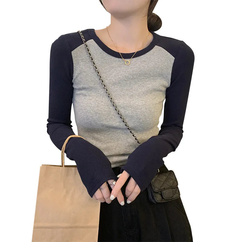 Dark blue women's oversized viscose top with embroidery and long princess sleeves on a hanger.