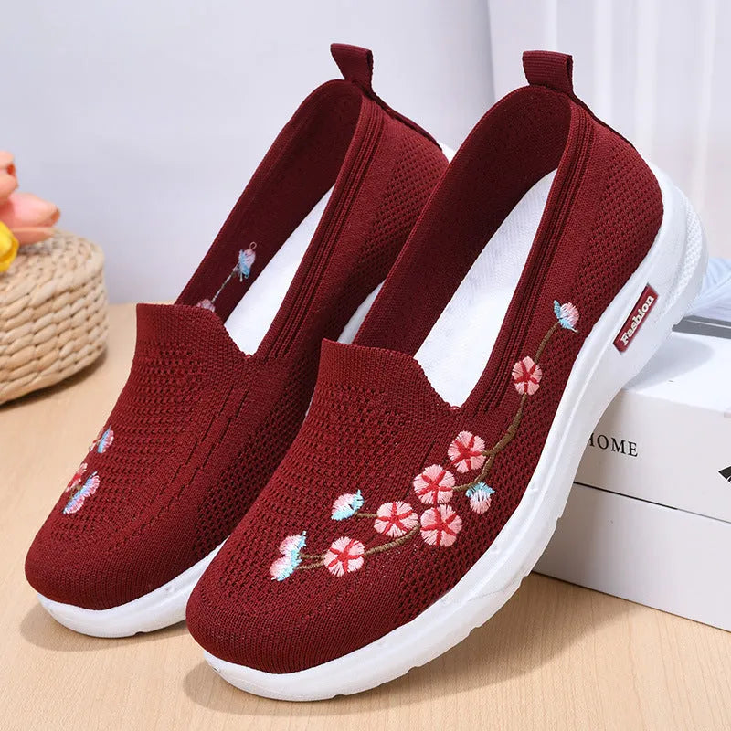 Women's wine red embroidered floral sports pumps with a flat heel and anti-slip sole on a white background.