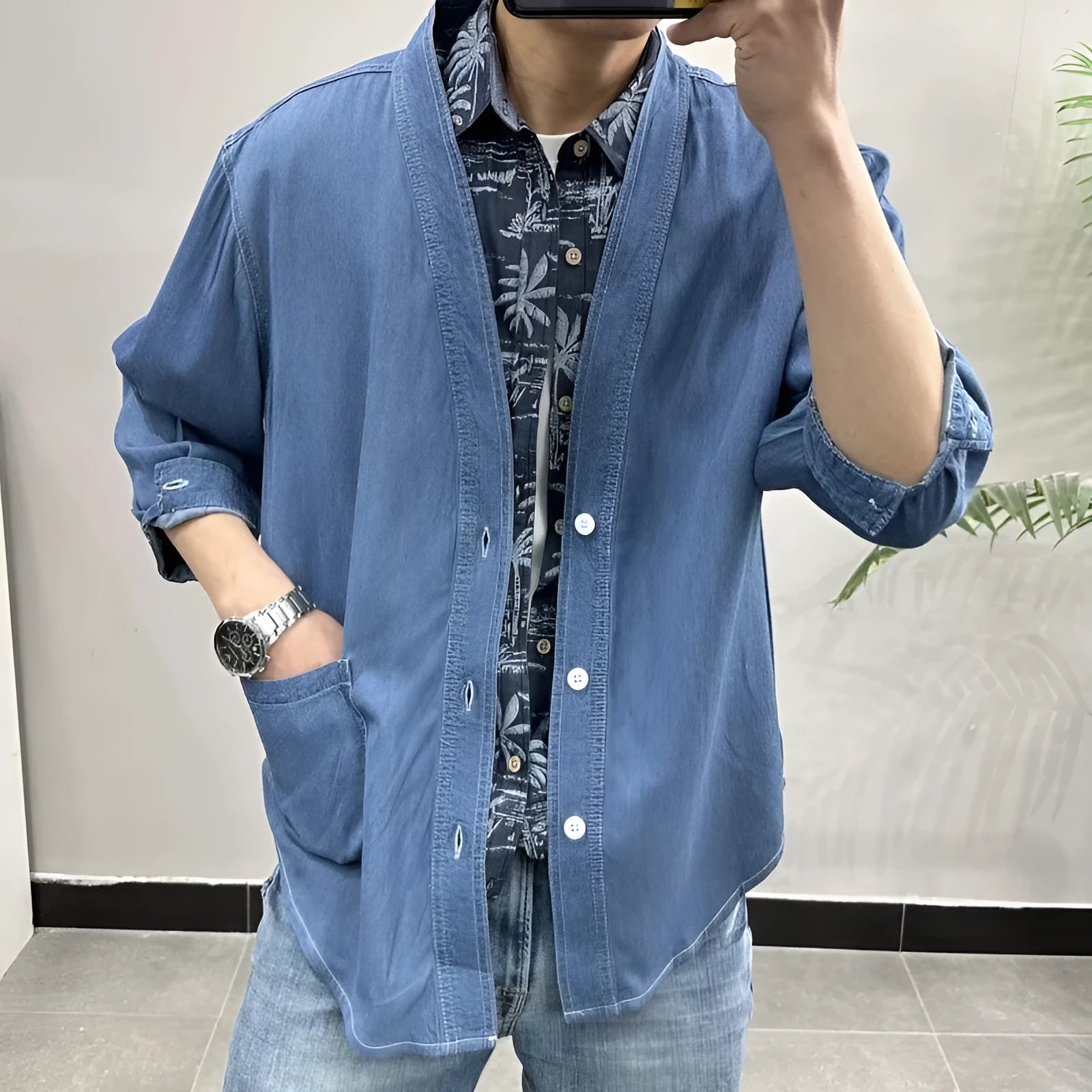 Men's dark blue casual denim coat with V-neck collar and chest pocket on a hanger.