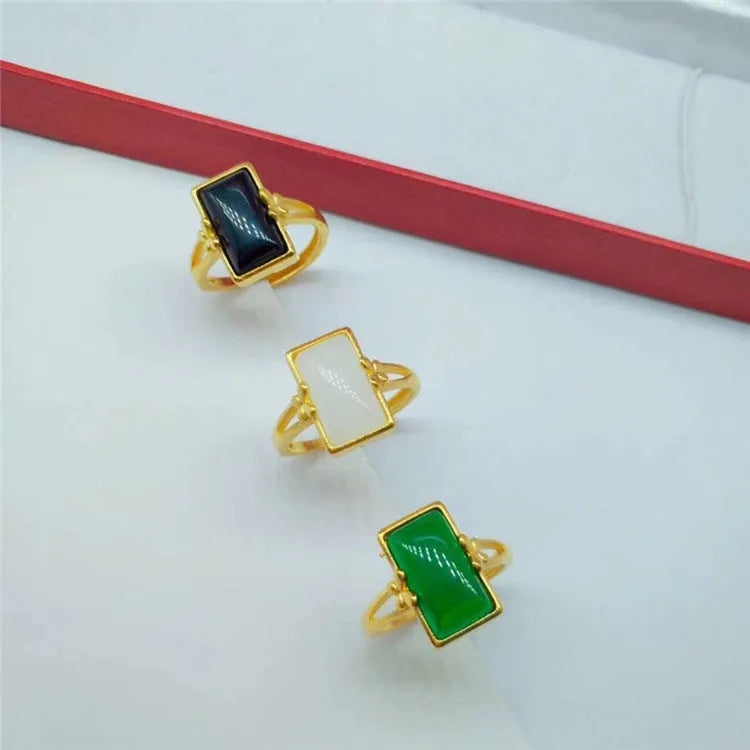 Gold-plated brass ring with a long green gemstone on an adjustable band.