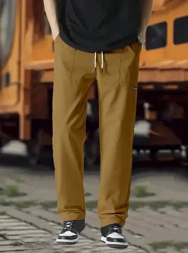 Men's light grey polyester trousers for spring and autumn wear, laid flat.