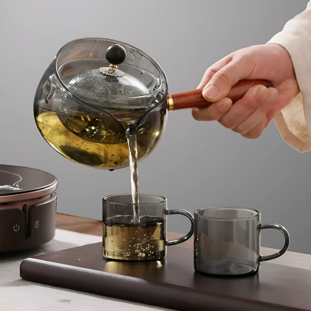 Rotating glass teapot with wooden handle and stainless steel infuser basket
