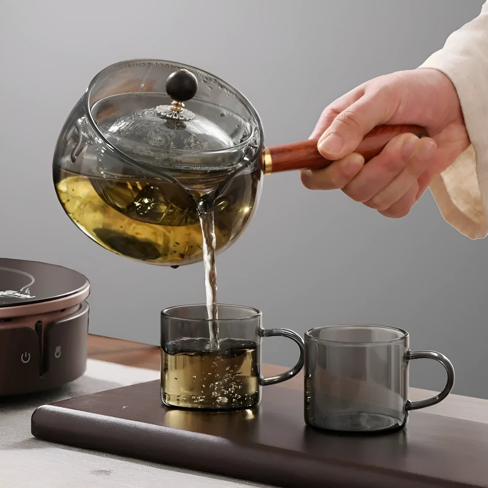 Rotating glass teapot with wooden handle and stainless steel infuser basket