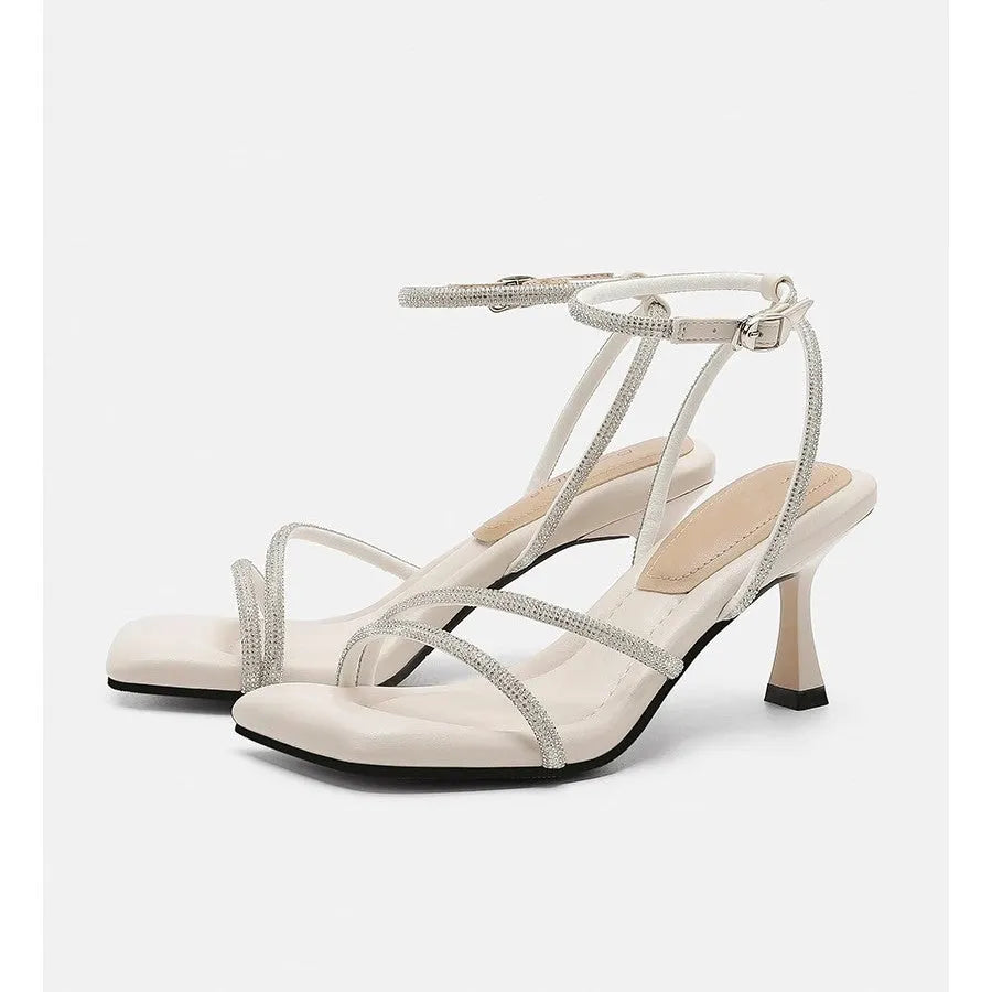 Women's silver rhinestone ankle-strap sandals with a square toe and buckle fastening.