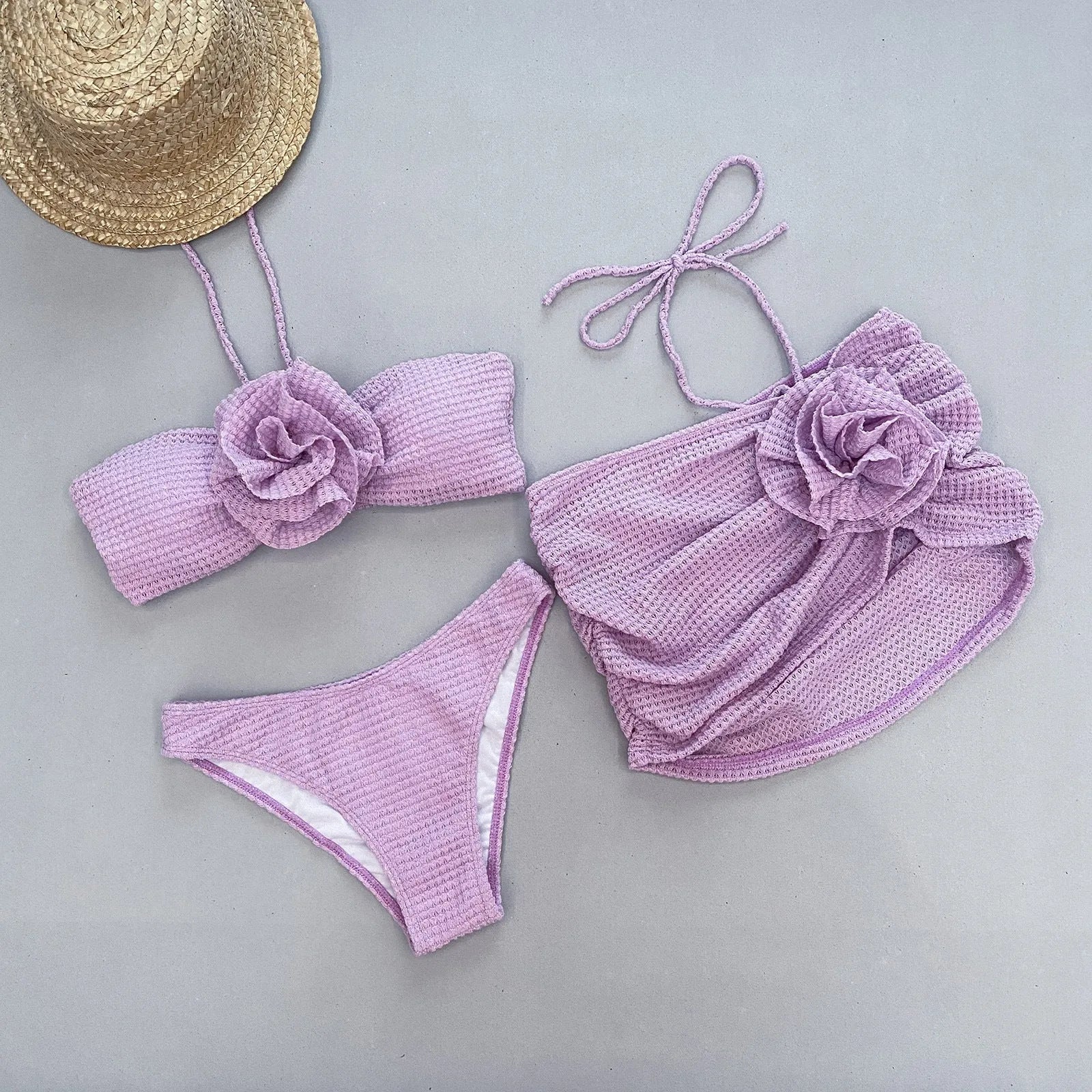 Women's 3D flower split three-piece bikini set in white or purple.