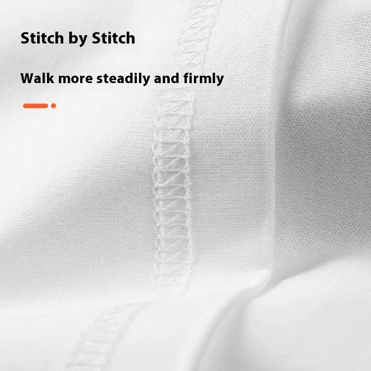 Men's loose fit solid colour cotton T-shirt on a hanger, shown in black and white.