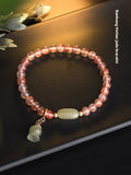 Ice float nanhong agate bracelet with floral shape and bamboo joint design on a wrist.