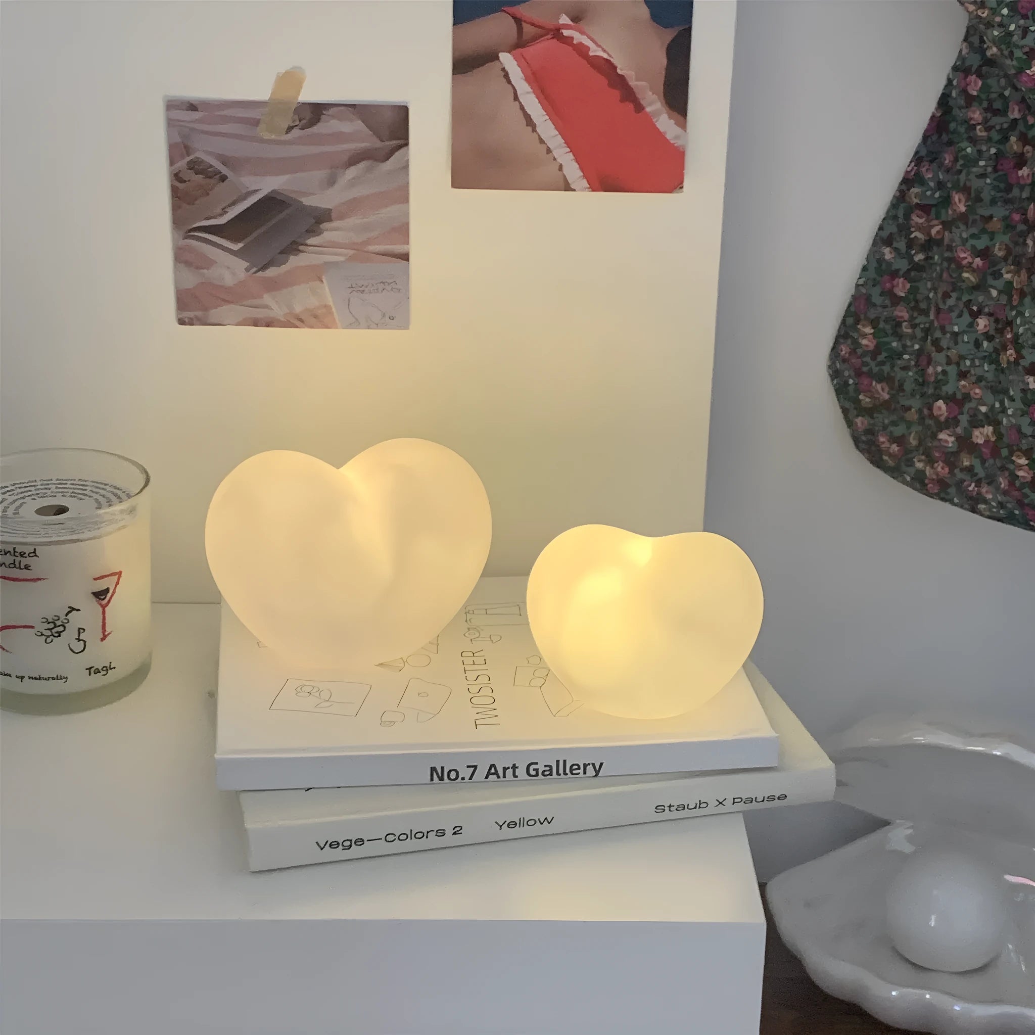 Pink and white vinyl trumpet-shaped atmosphere lamps in two sizes on a table