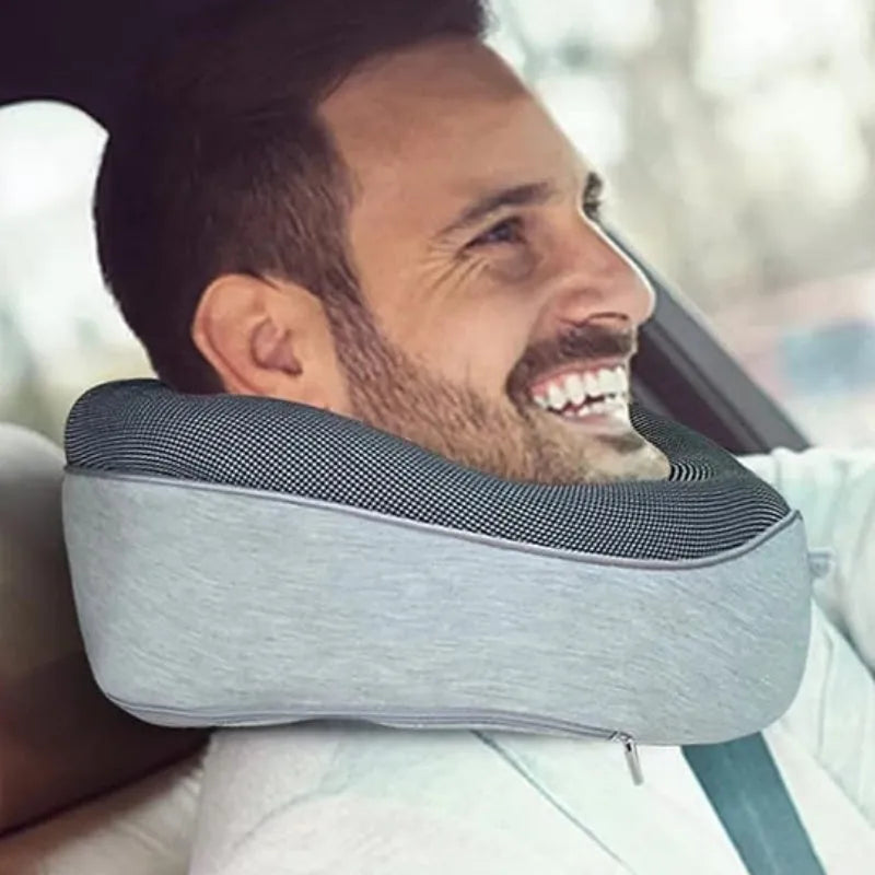 U-shaped navy blue travel neck pillow with memory foam, shown rolled up next to its carry bag.