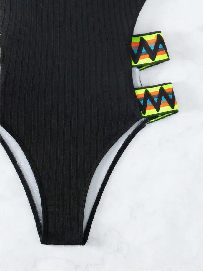 Women's solid colour one-piece swimsuit in black or orange on a mannequin