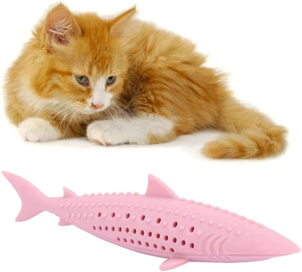 Green dolphin-shaped silicone cat chew toy with side holes on a white background