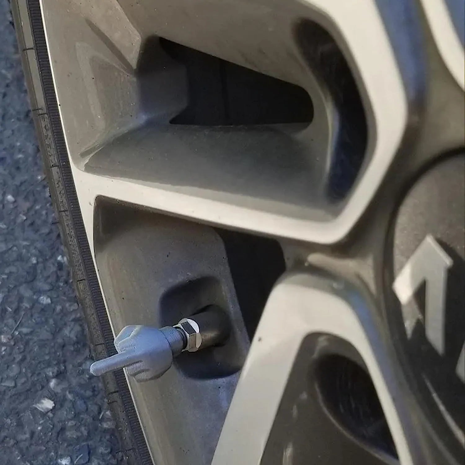 Four latex car tyre valve caps - two black and two skin colour pieces