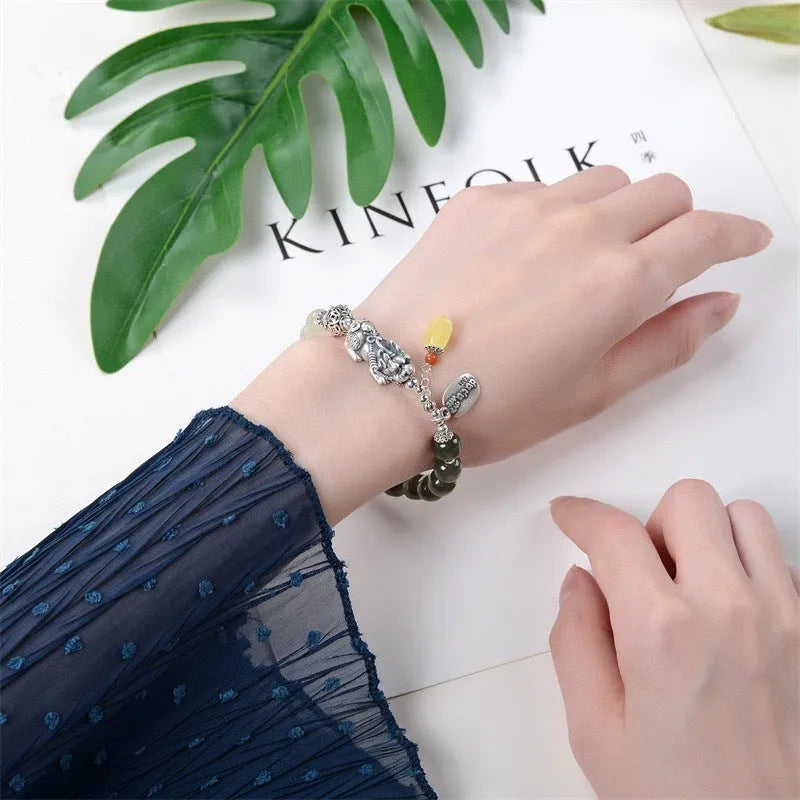 Retro-style pure silver bracelet for women with natural Hetian jade bead pendants.