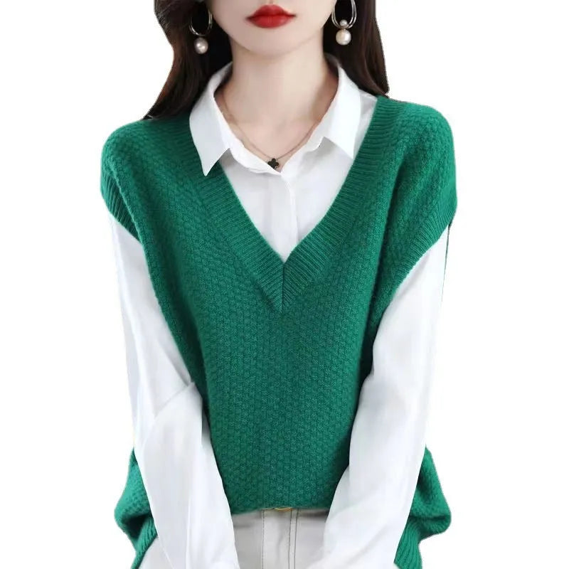 Women's creamy-white sleeveless v-neck knit vest with a 3D textured pattern, laid flat.