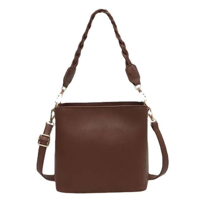 Retro woven PU leather crossbody bucket bag in an androgynous style.