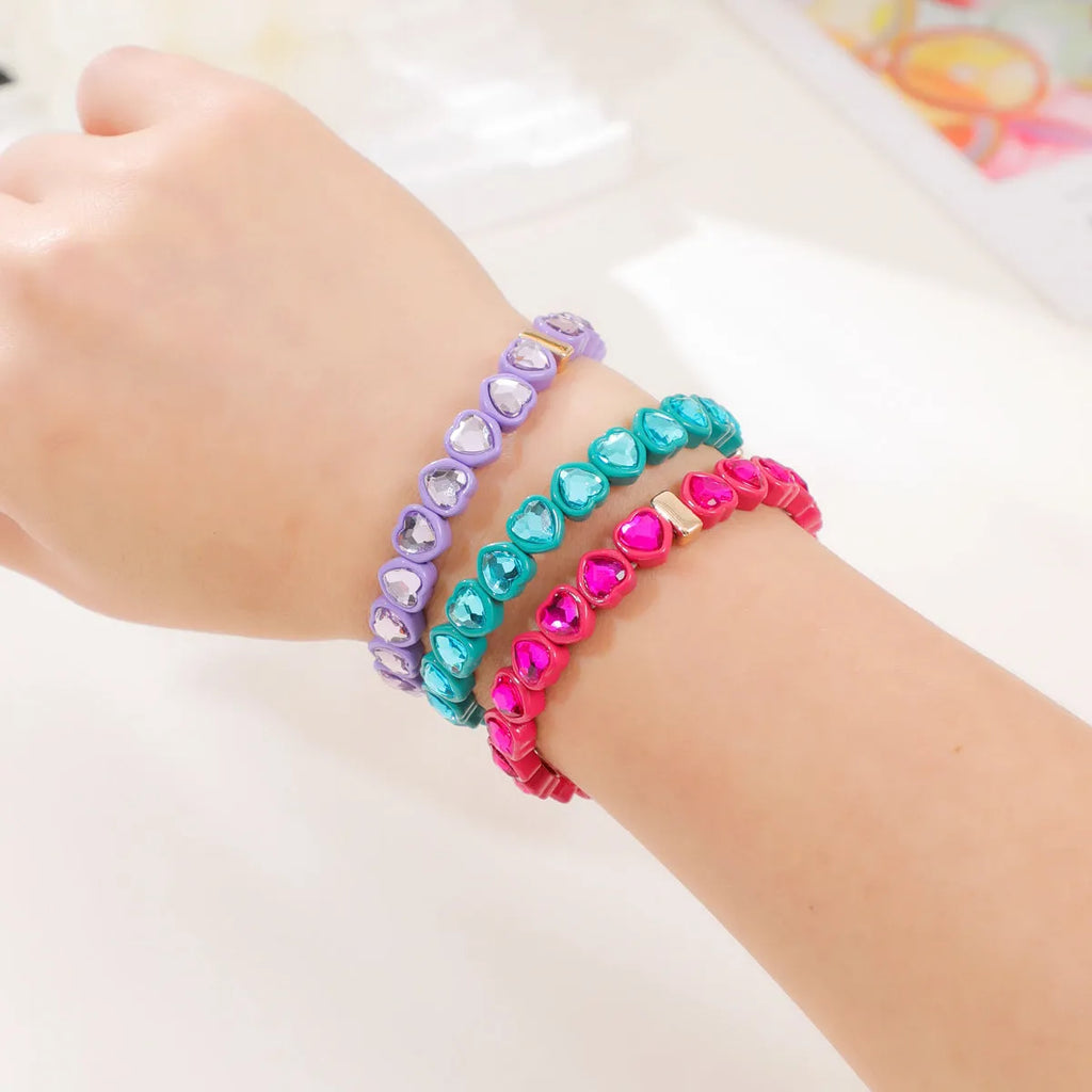 Colourful enamel finish alloy heart charm on a black stretch bracelet band.