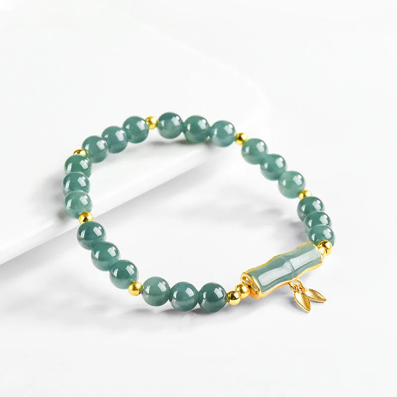 S925 sterling silver bracelet for women with a blue water round bead and cargo jade charm.