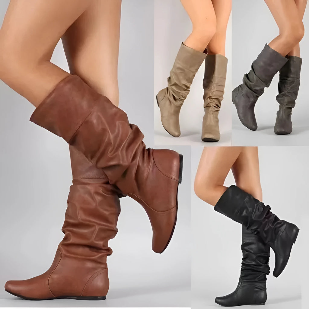 Women's black slip-on flat boots with a round toe and high cylinder shaft.