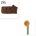 Hand holding a white and pumpkin coloured pet grooming brush with many stainless steel needles.